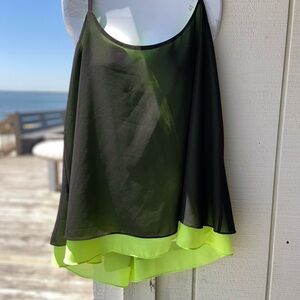 Black and chartreuse glossy top with adjustable straps, and a flowing open back.